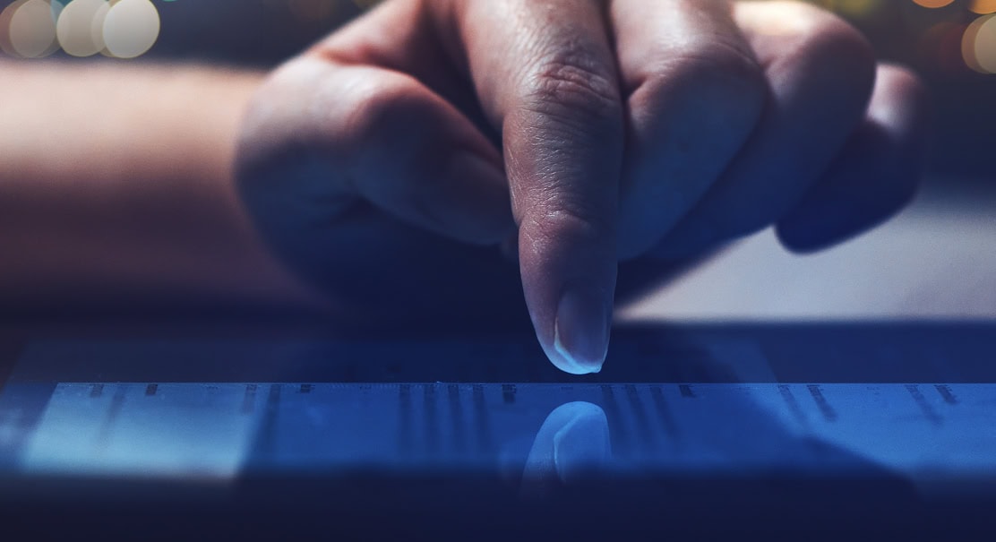 A finger over a tablet screen